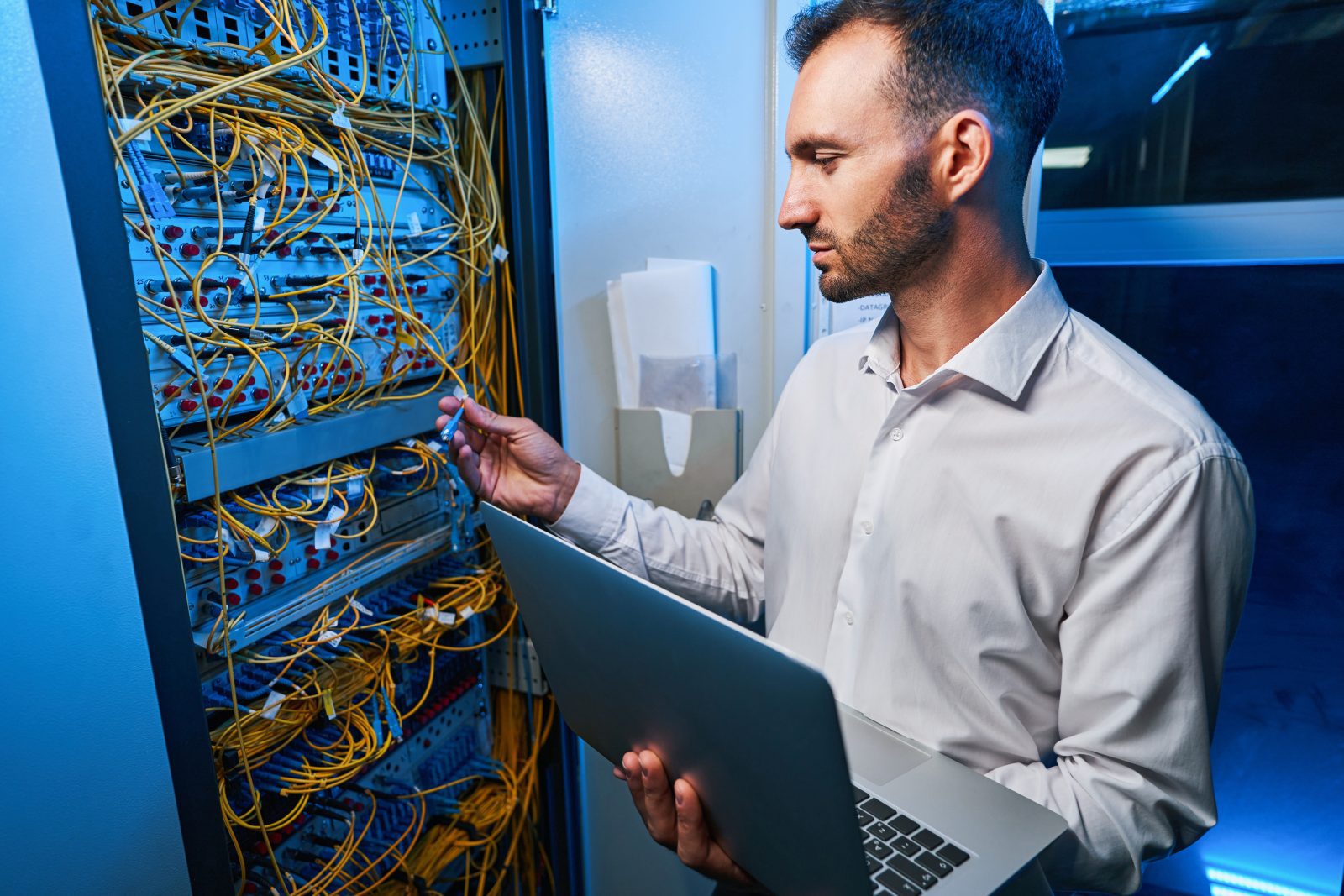 male it engineer connecting cable to server rack 2023 11 27 04 57 47 utc